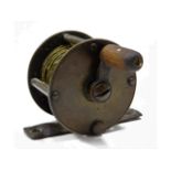 A vintage brass fishing reel, 38mm diameter