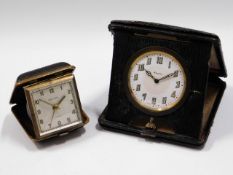 Two travel clocks, an Estyma & an eight day, both
