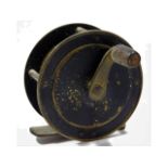 A vintage brass fishing reel, 57mm diameter