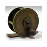 A vintage brass fishing reel, 51mm diameter