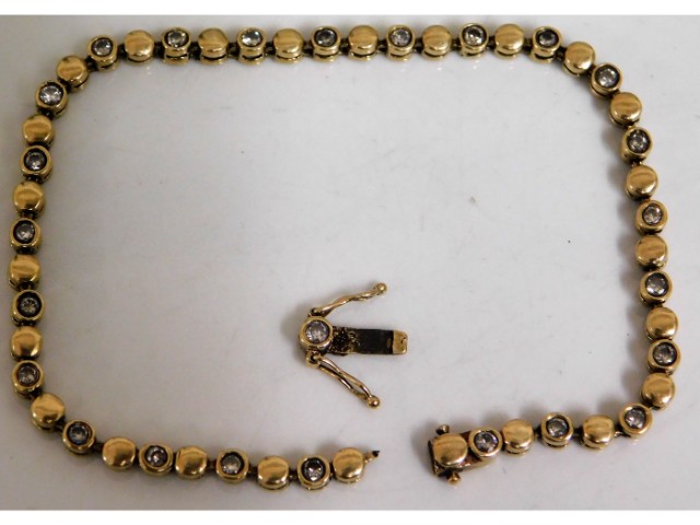 A 9ct gold bracelet set with 25 diamonds of approx