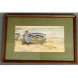 A framed watercolour of girl & rowing boat on beac