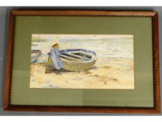 A framed watercolour of girl & rowing boat on beac