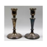 A pair of hallmarked silver candlesticks, inscribe