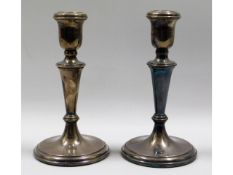 A pair of hallmarked silver candlesticks, inscribe