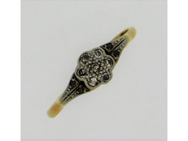 An early 20thC. 18ct gold ring set with eleven pla