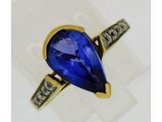 An 18ct gold tanzanite ring set with ten small dia