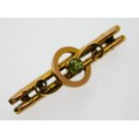 An antique 9ct gold brooch set with peridot, 37mm