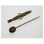 A 9ct gold tie pin set with small diamond twinned