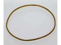 A 9ct gold bangle, 63mm internal measurement at wi