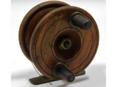A vintage wood & brass fishing reel, small crack t