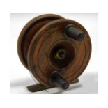 A vintage wood & brass fishing reel, small crack t