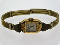 A ladies 18ct gold & enamel cased watch with worn