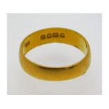 A 22ct gold band, misshapen, size N/O, 3.4g