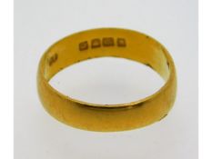 A 22ct gold band, misshapen, size N/O, 3.4g