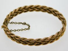 A 9ct gold woven style bangle, 58mm internally at