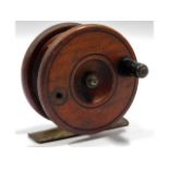 A wooden & brass fishing reel, lacking one handle,