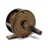 A vintage brass fishing reel, 50mm diameter