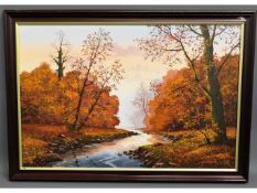 A framed oil on canvas depicting autumnal River Pl
