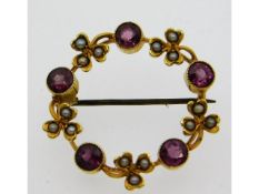 A yellow metal brooch set with garnets & pearl, wi