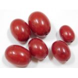 Six cherry amber beads, 27.9g