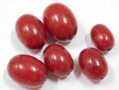 Six cherry amber beads, 27.9g