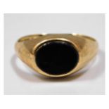 A 9ct gold signet ring set with onyx, size O/P, 2.