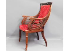 An antique upholstered arm chair, possibly walnut,