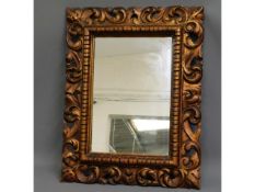 An ornate, antique gilt framed mirror, originally