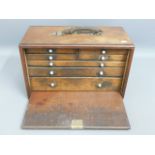 An antique tool box with seven drawers, 18in wide