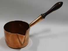 A 19thC. heavy gauge copper milk pan with polished