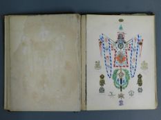 An antique heraldry scrap book with cut outs & han