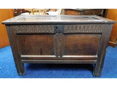 An 18thC. oak coffer with carved decor to front, o