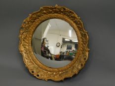 A convexed circular mirror with gilt frame, 14.75i