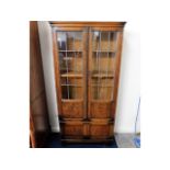 An oak glass fronted bookcase with shelves & cupbo