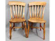 A pair of 19thC. elm farmhouse dining chairs