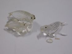 A mounted pair of Swarovski crystal seals, one fli