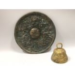 An antique bronze disc with figurative moulded dec