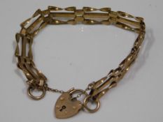 A 9ct gold three bar gate bracelet, 6in long, 7.3g