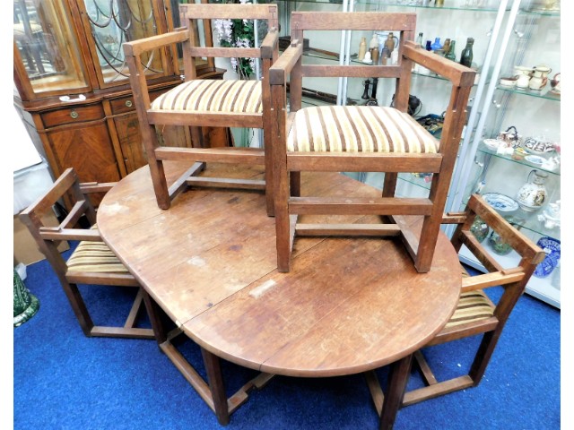 An arts & crafts dining suite with four chairs, ta