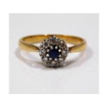 An 18ct gold diamond & mid blue sapphire ring, siz