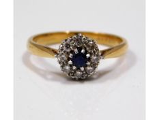 An 18ct gold diamond & mid blue sapphire ring, siz