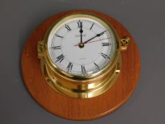 A mounted Vetus brass quartz ships clock, 7.7375in