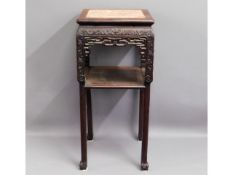 A c.1900 carved Chinese hardwood pot stand with in