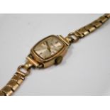 A 9ct gold cased ladies watch with steel strap