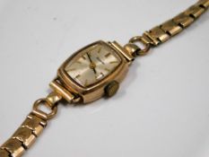 A 9ct gold cased ladies watch with steel strap