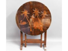 An Oriental tilt top occasional table with glass t