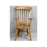 A c.1900 elm seated Windsor style armchair, 45.5in