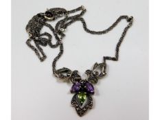 A silver necklace set with marcasite, amethyst & p