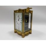 A brass serpentine fronted carriage clock, 6in tal